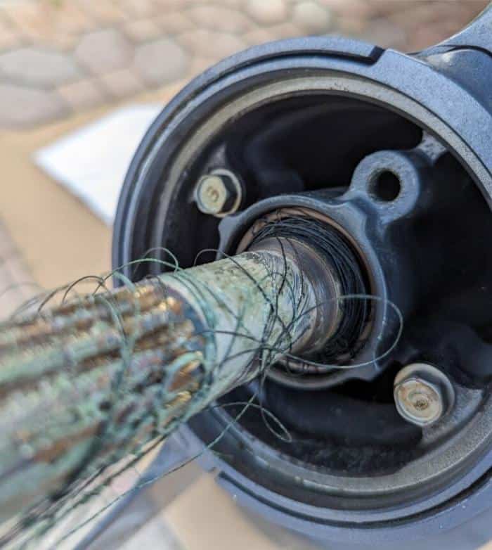 Fishing line wrapped behind an outboard propeller shaft