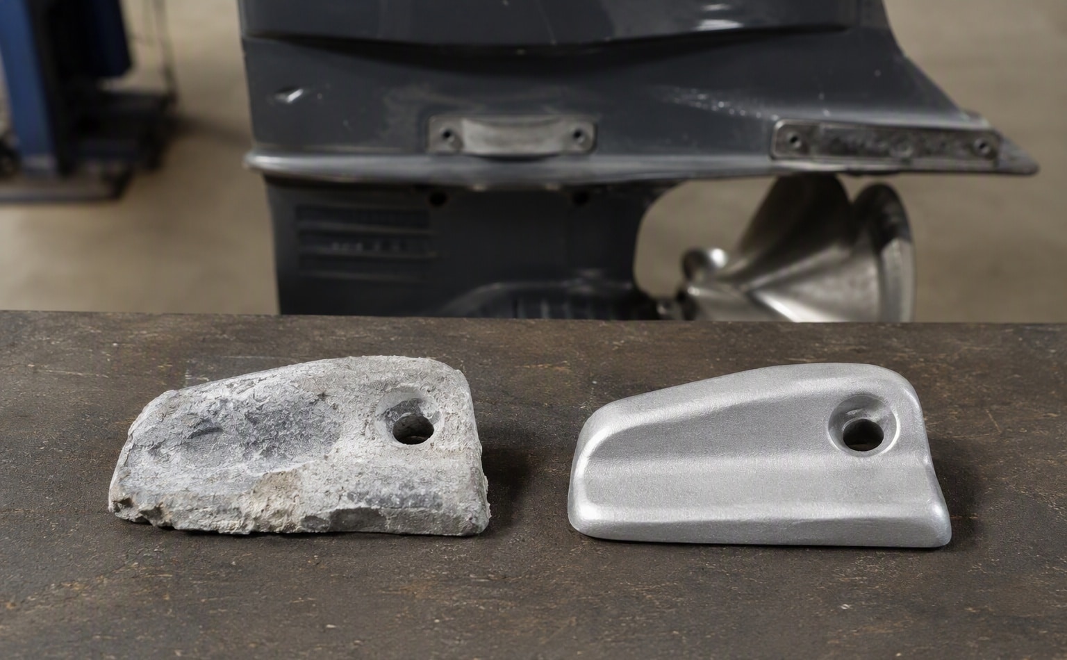 Worn sacrificial anode being replaced on an outboard